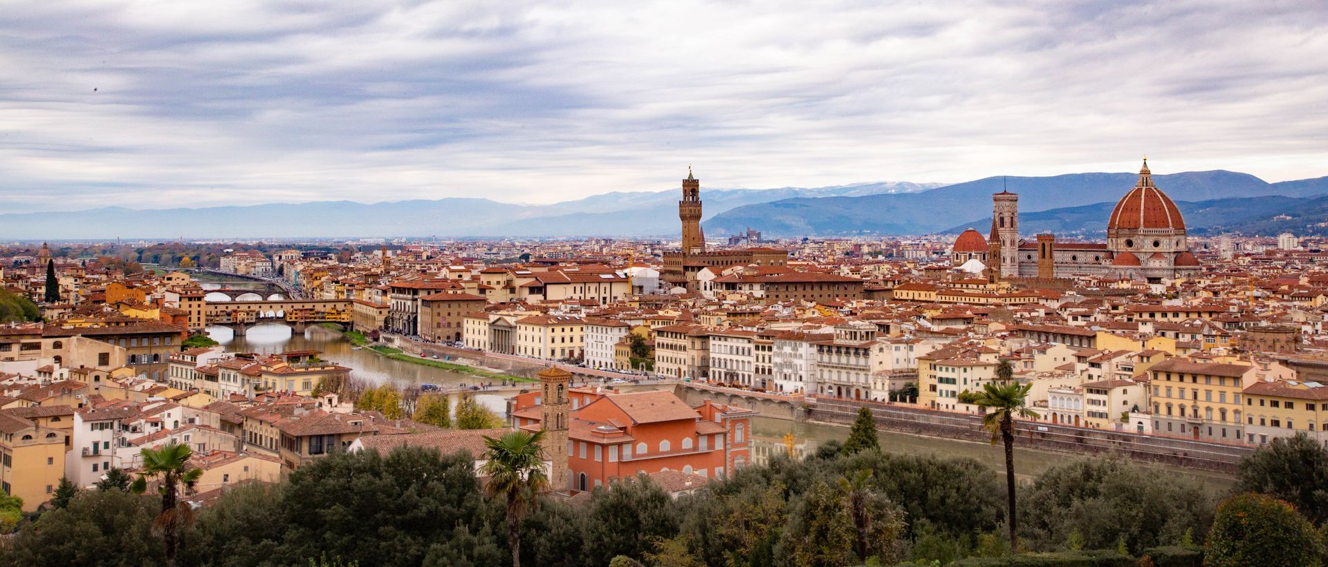 Panoramic view of Florence, Italy, with the Duomo and historic buildings at sunset