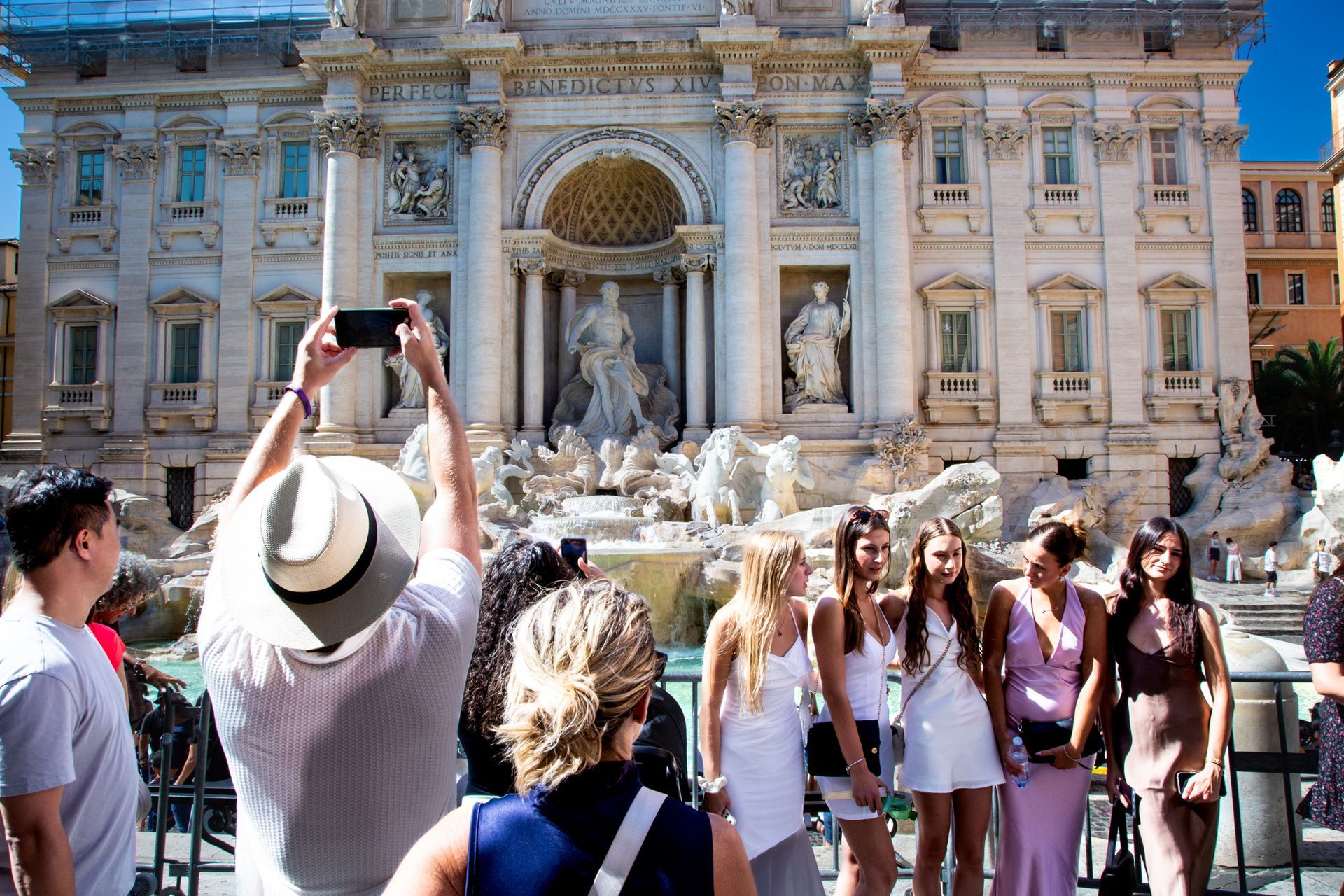 People taking photos in front of the Trevi Fountain in Rome, Italy.