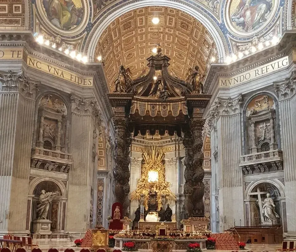Inside St. Peter's Basilica: elaborate altar beneath a canopy.