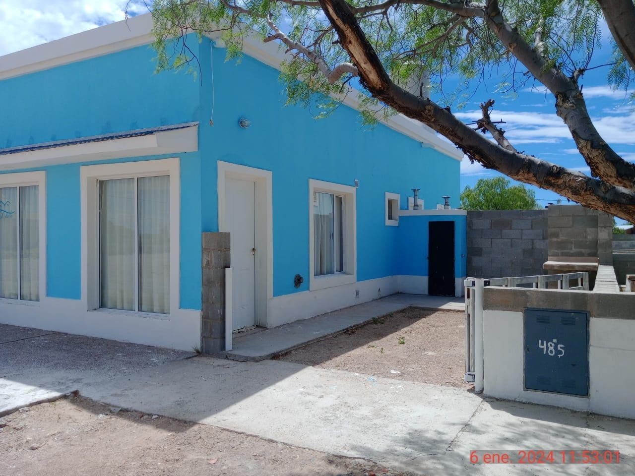 Blue house with white trim, door, and windows. The number 485 is visible.