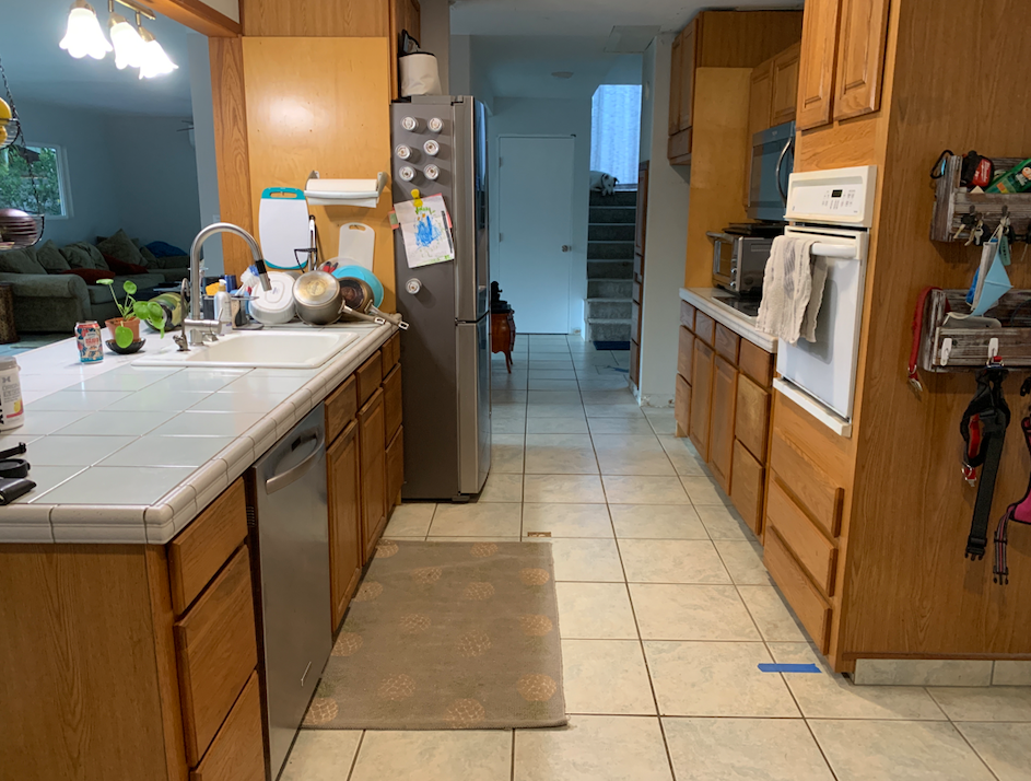 A kitchen with stainless steel appliances and wooden cabinets