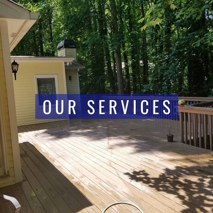 A yellow house with a wooden deck and surrounding trees, overlaid with a blue rectangle labeled