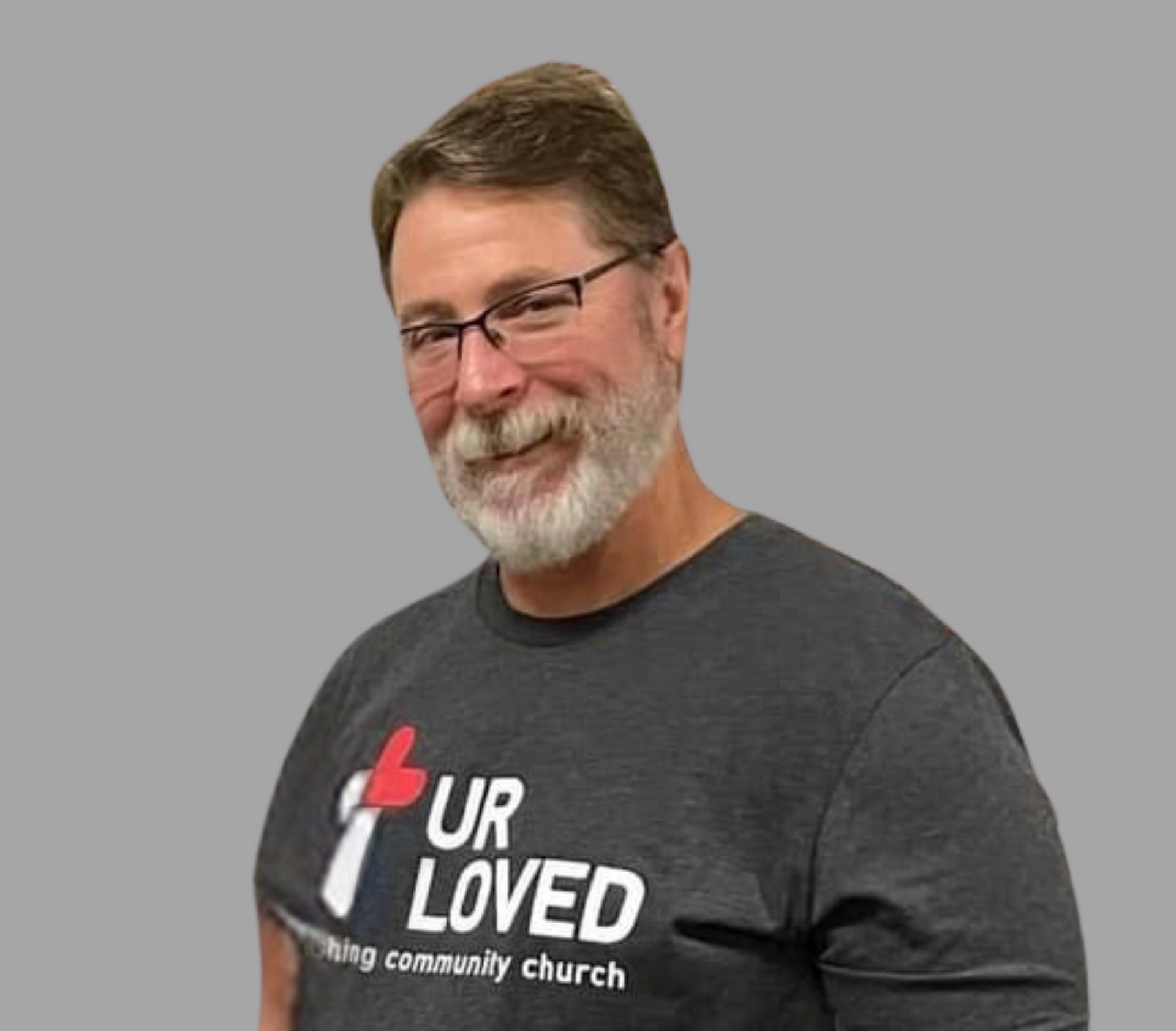 a man wearing glasses and a plaid shirt is smiling for the camera .