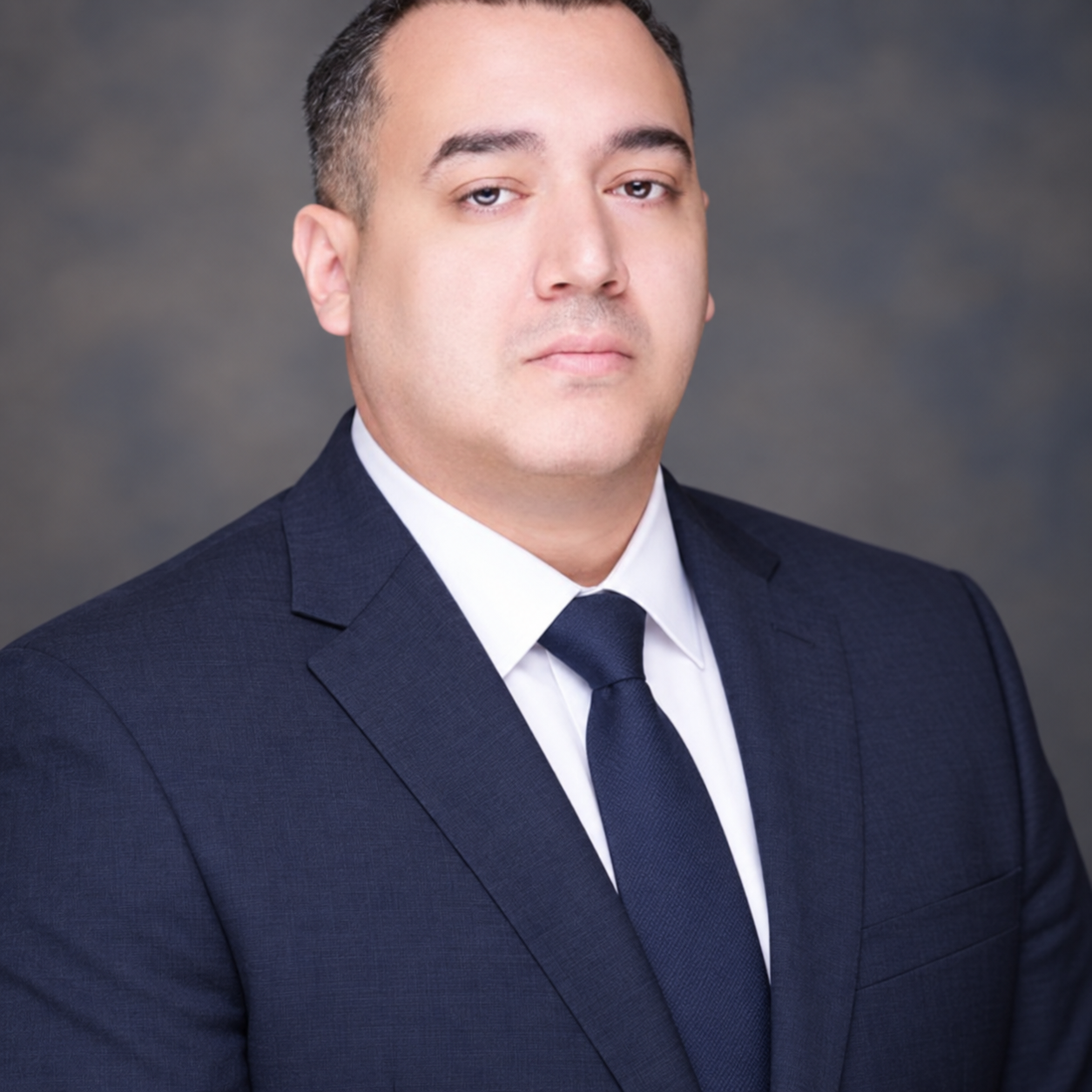 Daniel Alvarez, founder of Atlas North Exchange, in a navy suit, white shirt, and tie