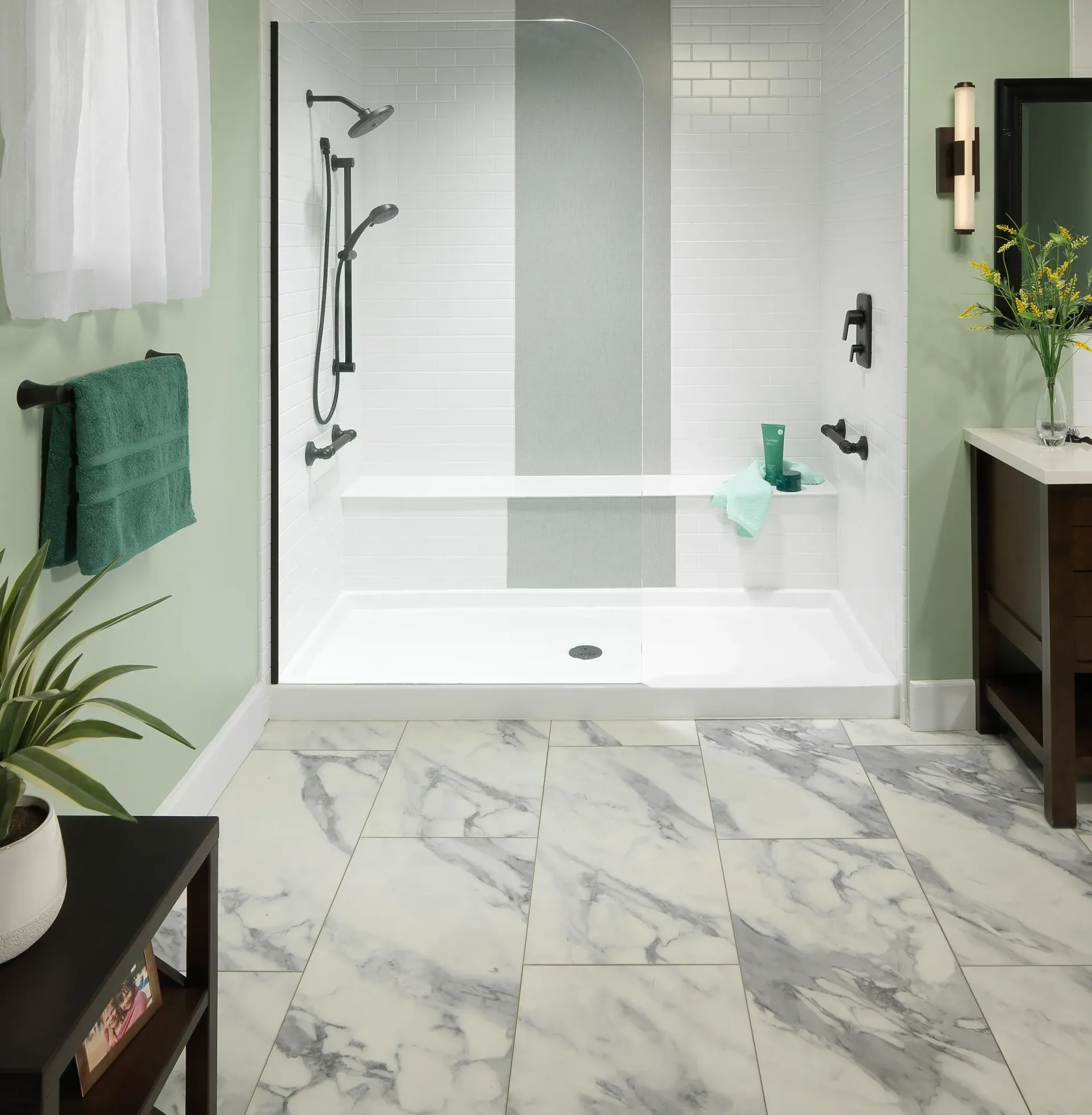 A green themed bathroom with white tiled shower.