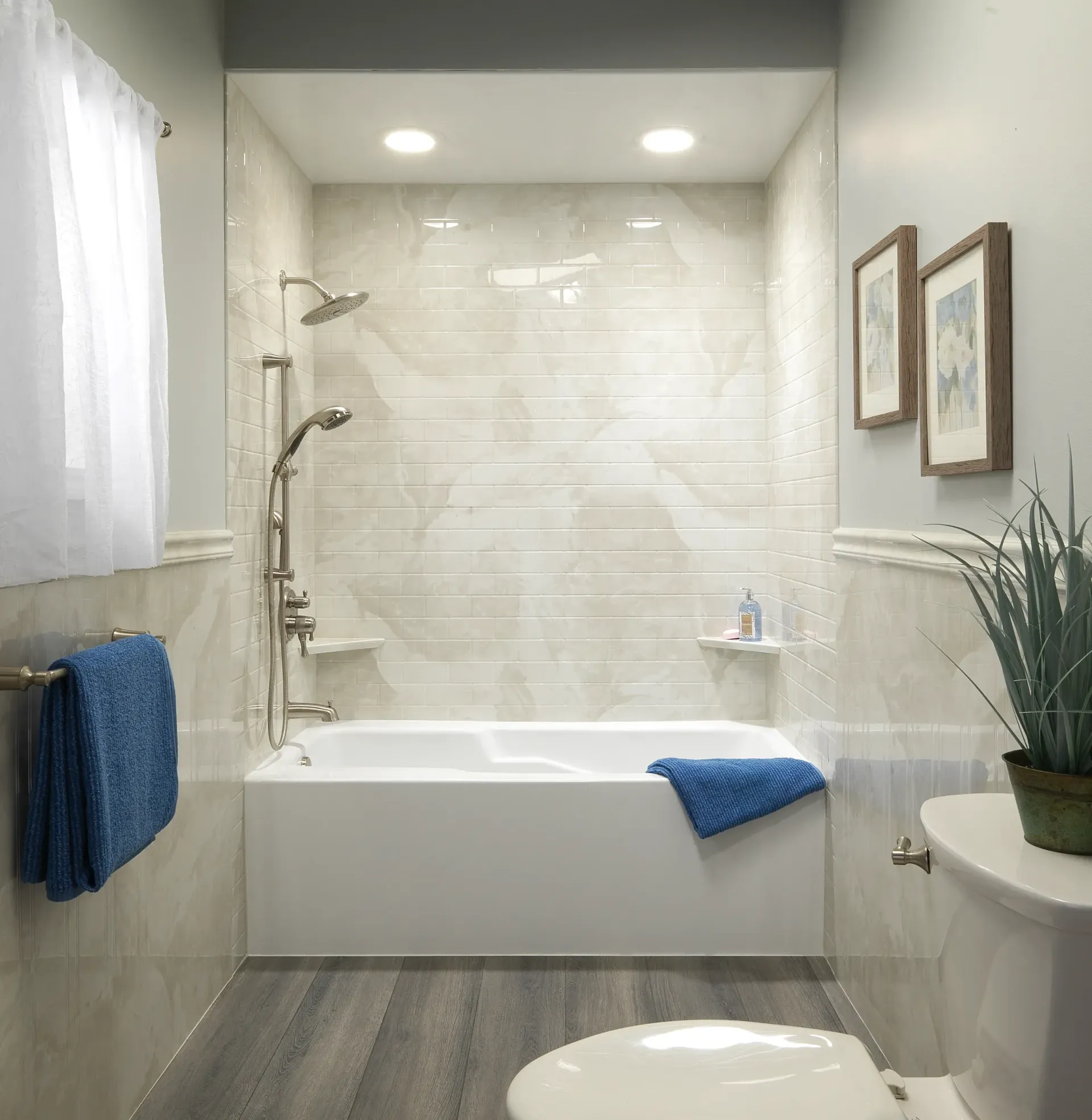 A tiled cream and tan marble shower.