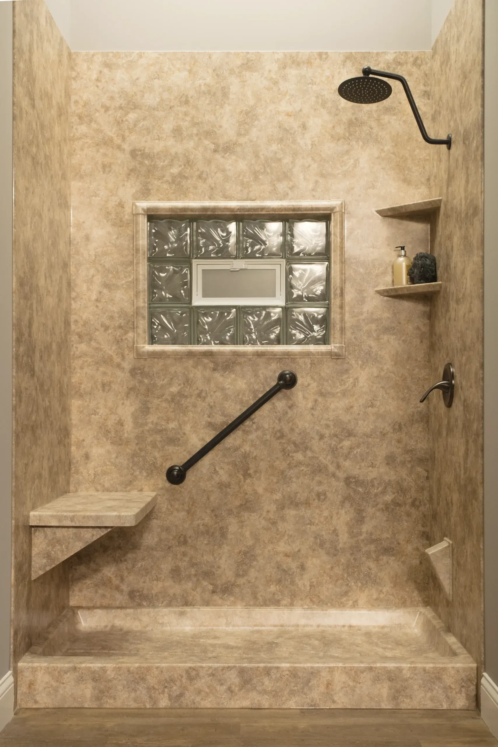 A textured tan rock shower with built-in window.
