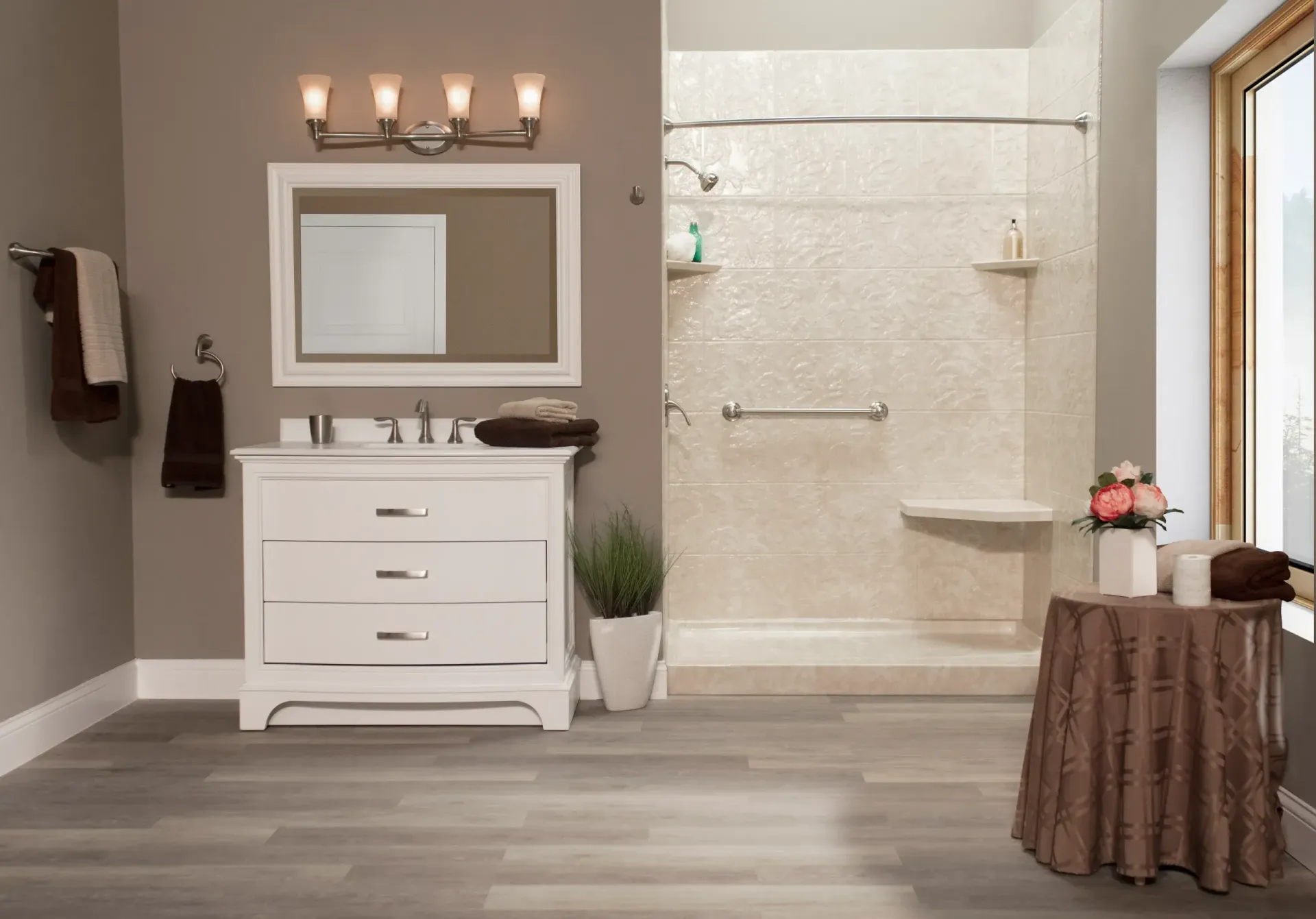 A dark tan bathroom with white furniture and vanity next to a textured tan shower with seating and grab bar.