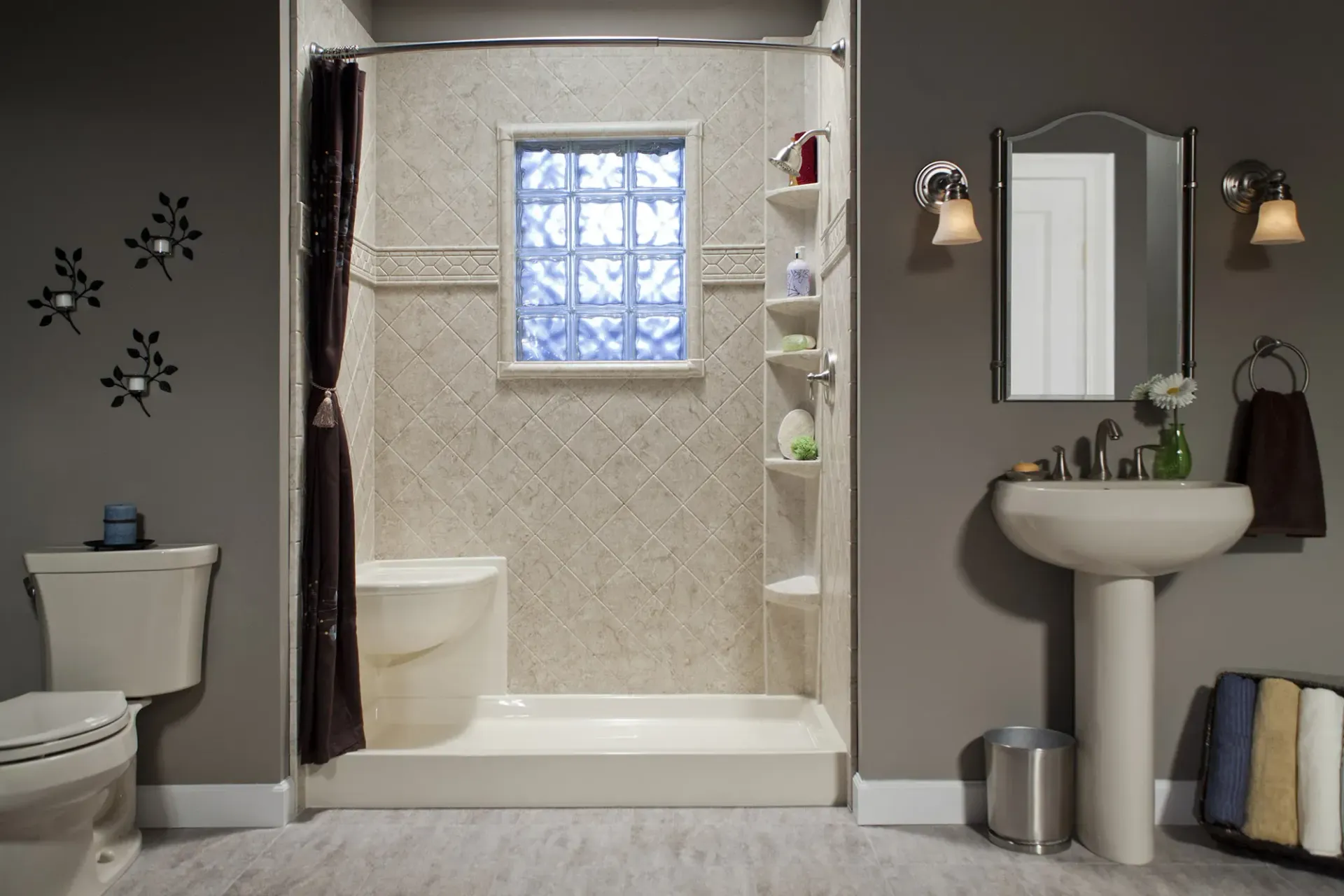A gray bathroom with textured tan shower with a seat and built-in window.