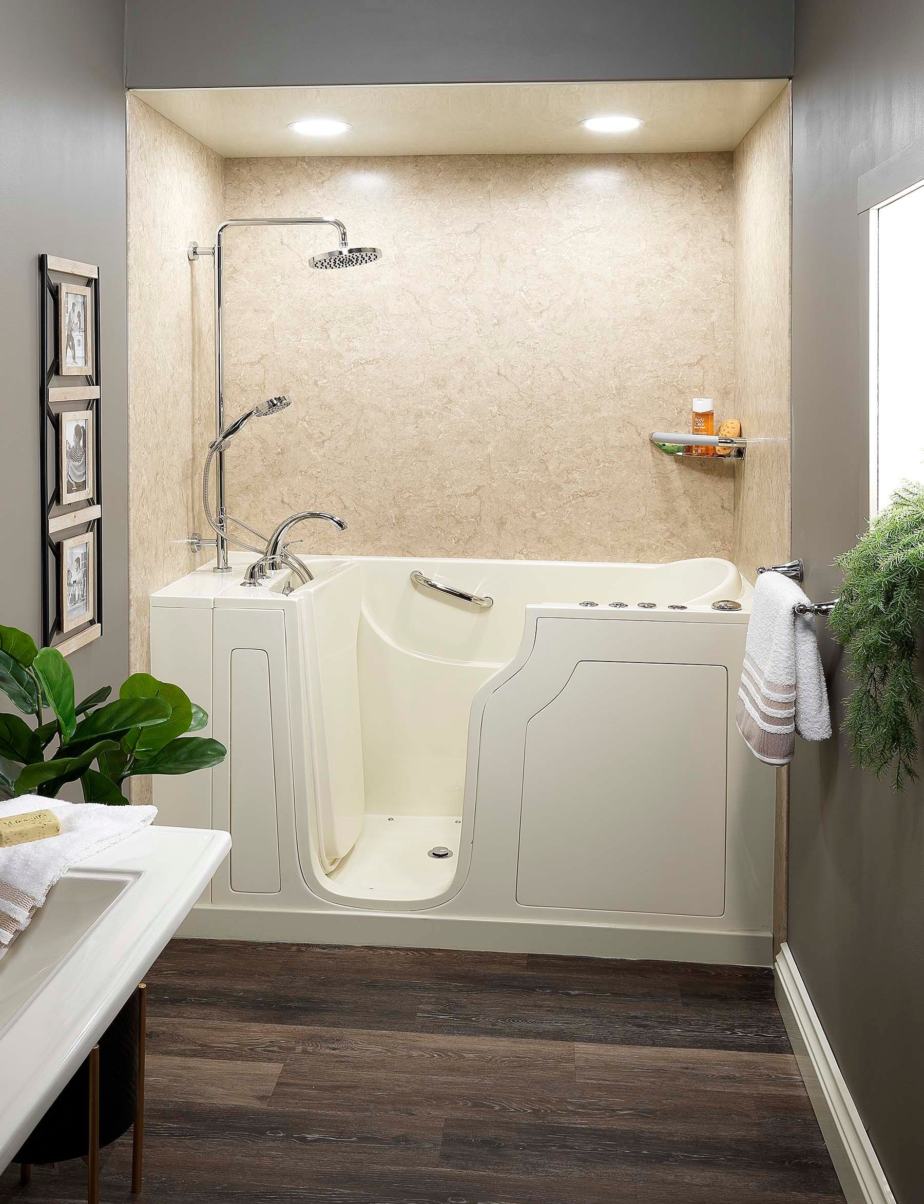 A gray bathroom with a tan textured shower that has chrome hardware.