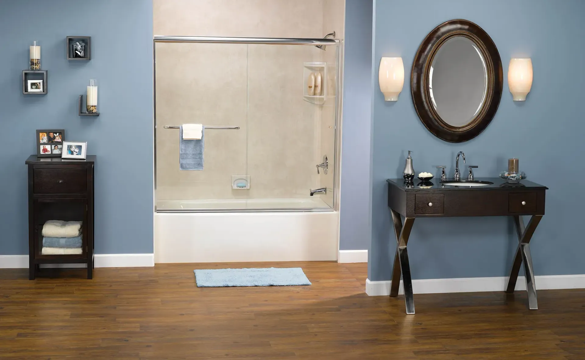 A bathroom with blue walls and dark wooden furniture with a white and cream colored shower.