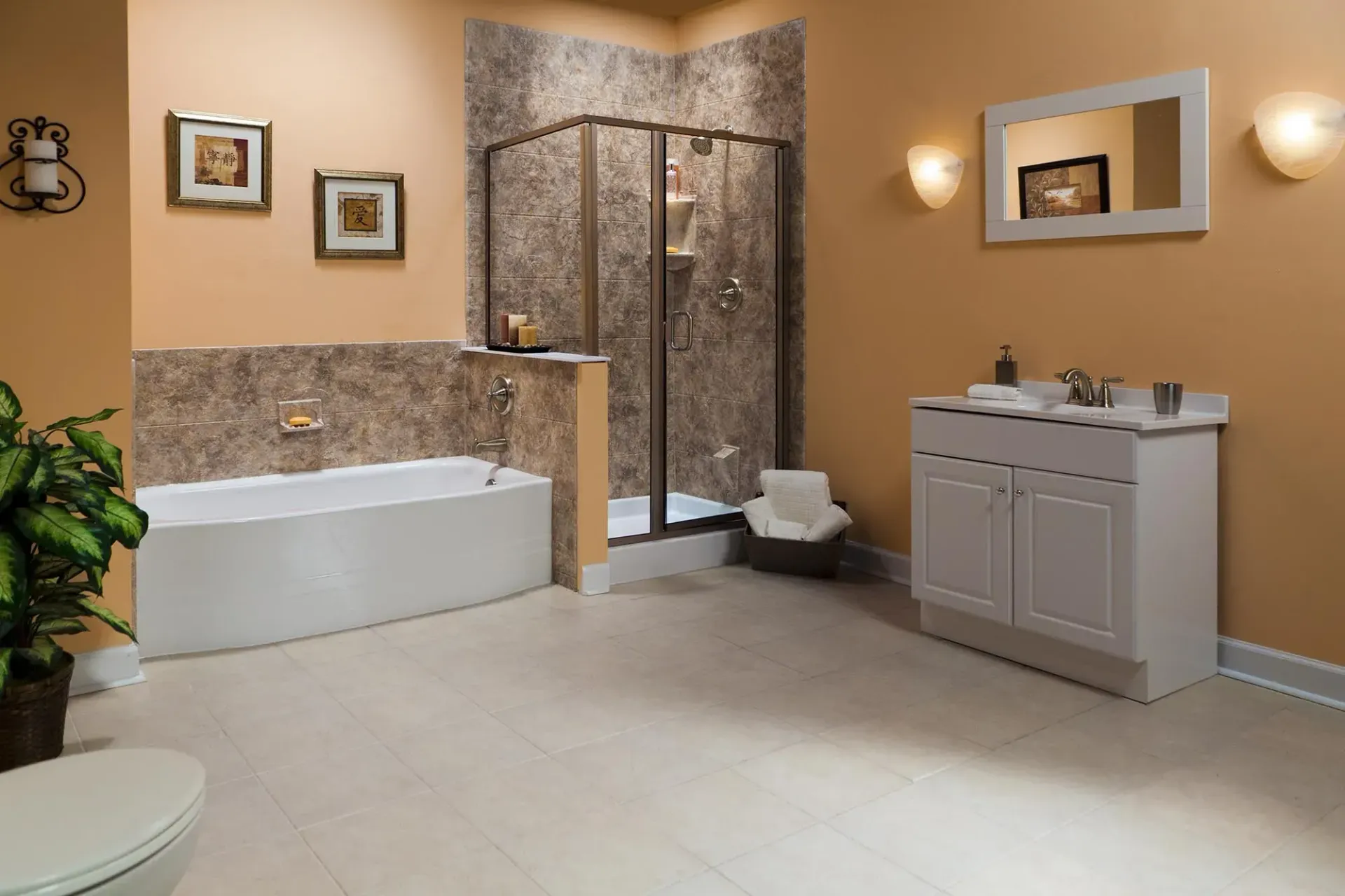 A dark rock wall stand-up shower next to a white standalone bathtub.