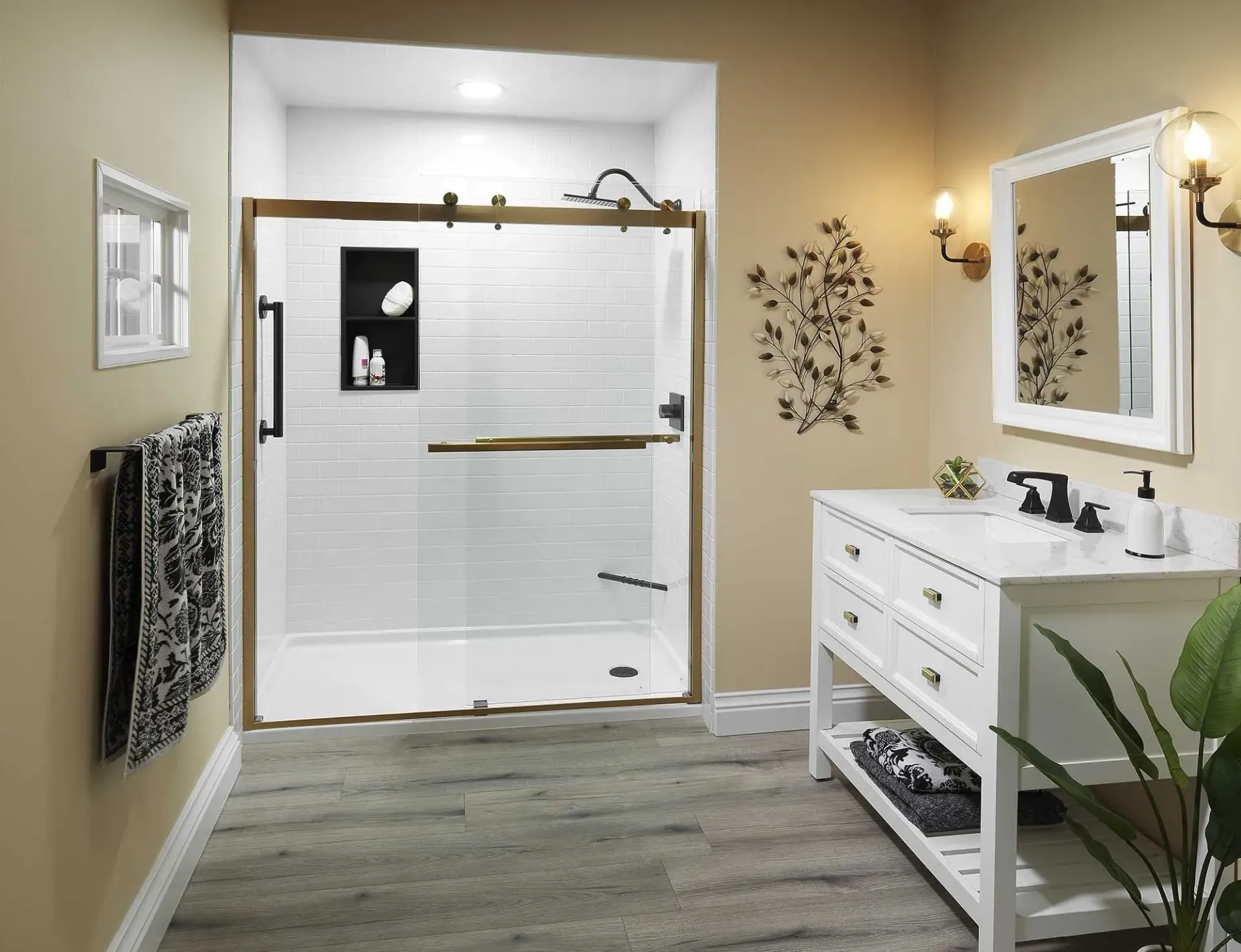 A yellow bathroom with white and brass shower.