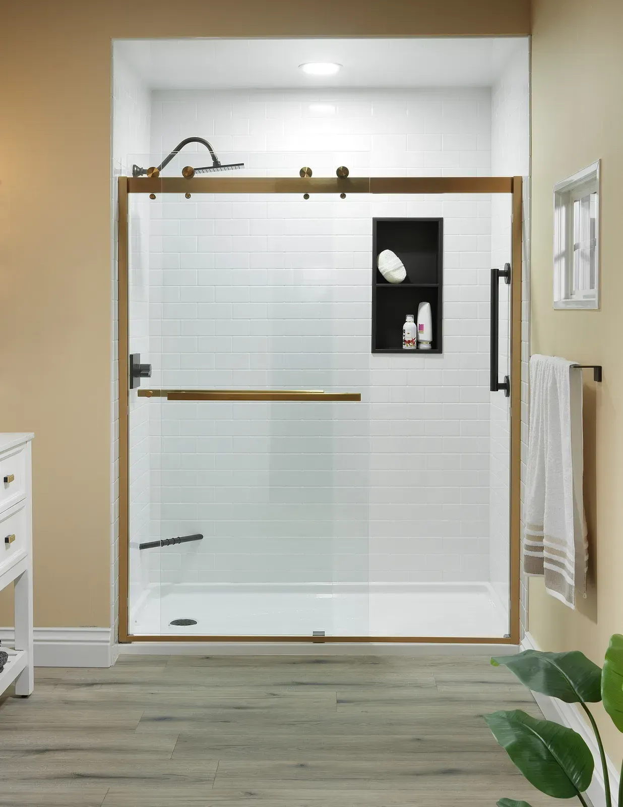 A white and black shower with a brass frame