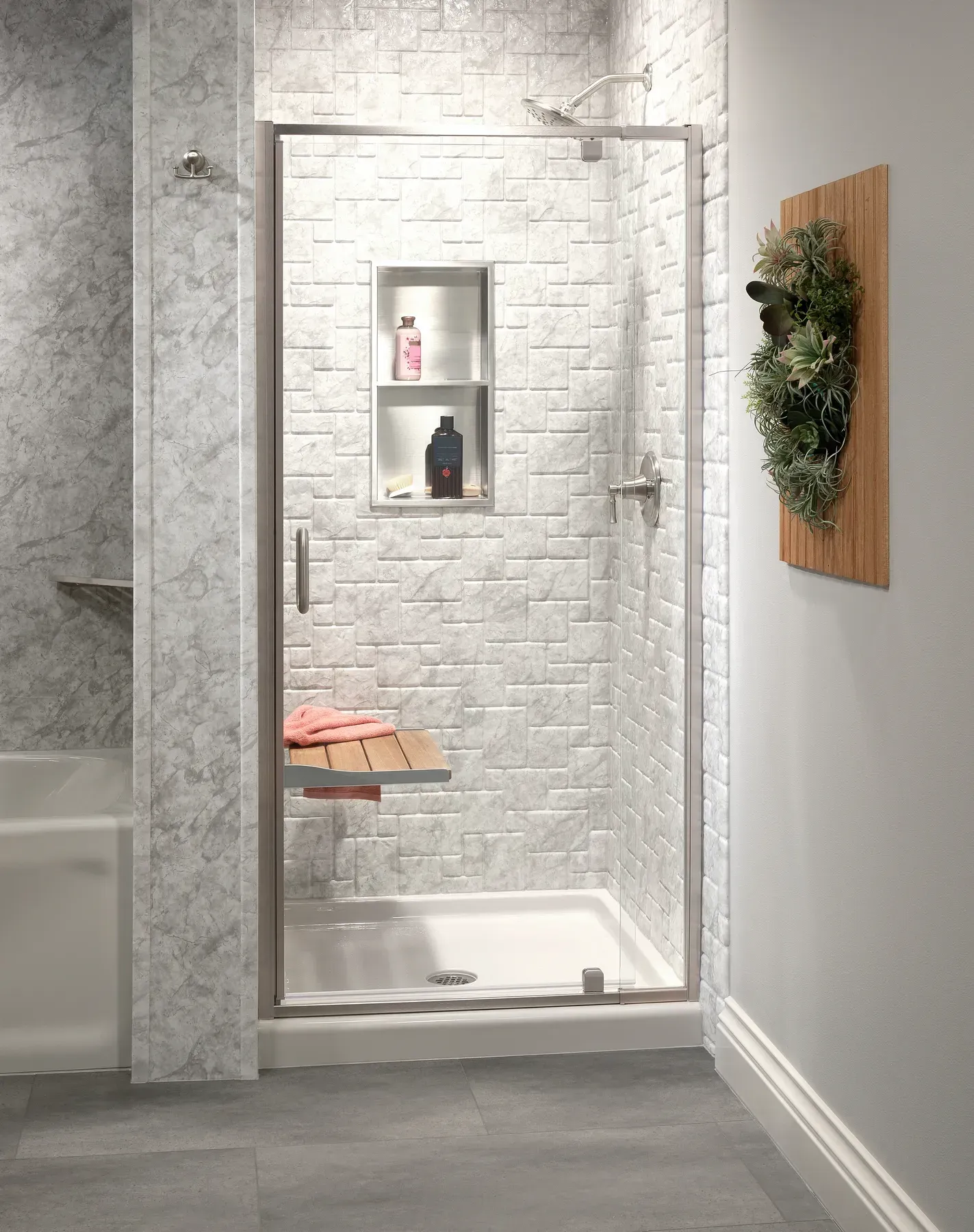A rock tiled shower with built in shelving