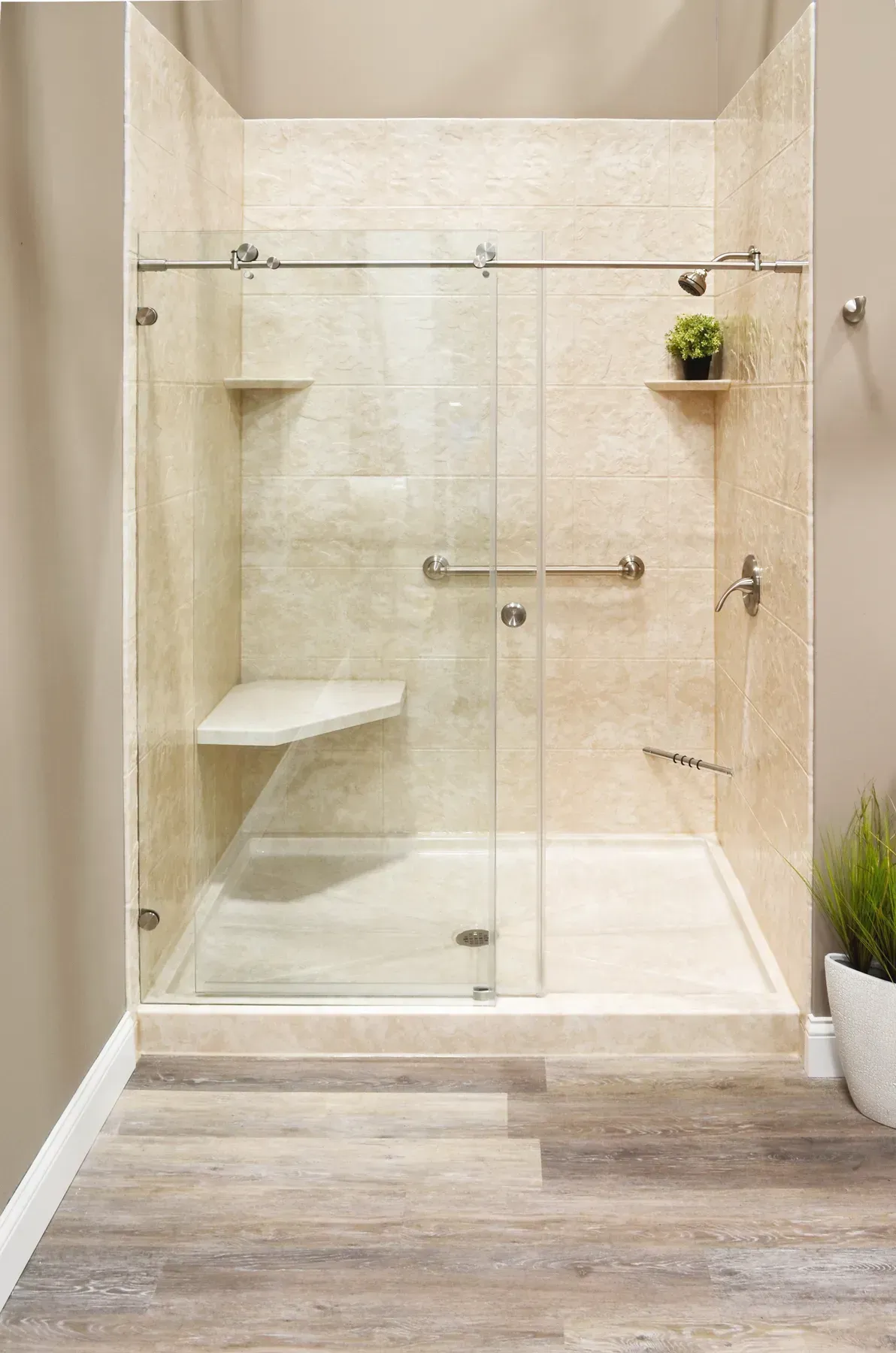A cream textured shower with glass sliding door.