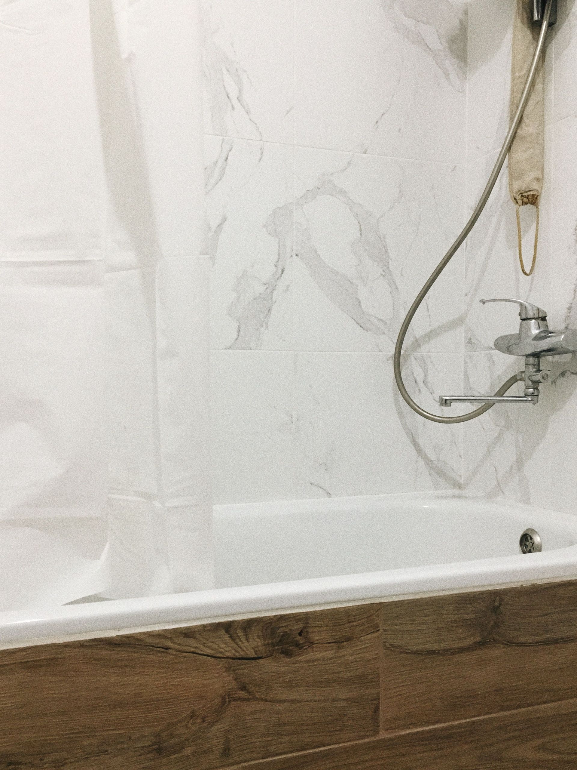 A close up of a marble shower wall.
