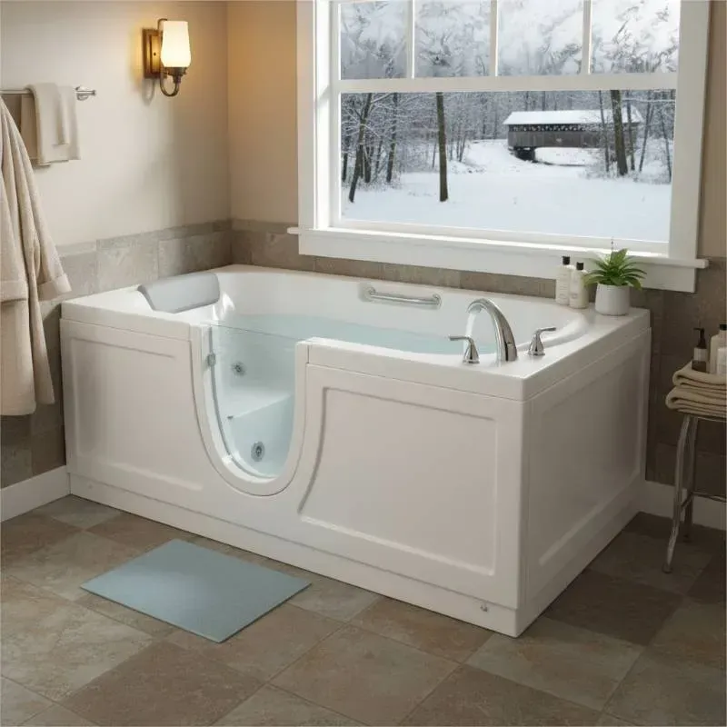 A bathroom with a wintery view outside that has a walk-in door that is transparent.