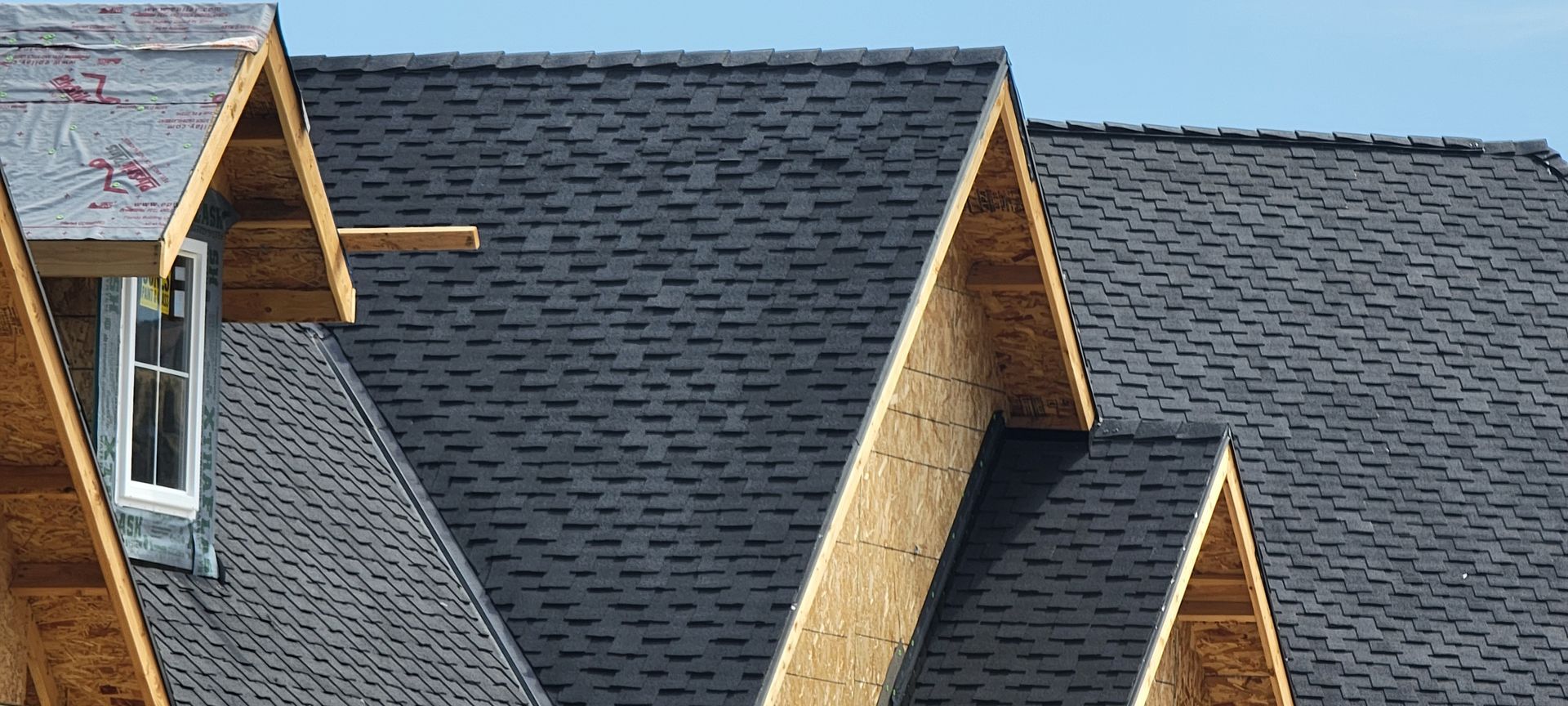 A man is working on the roof of a house.