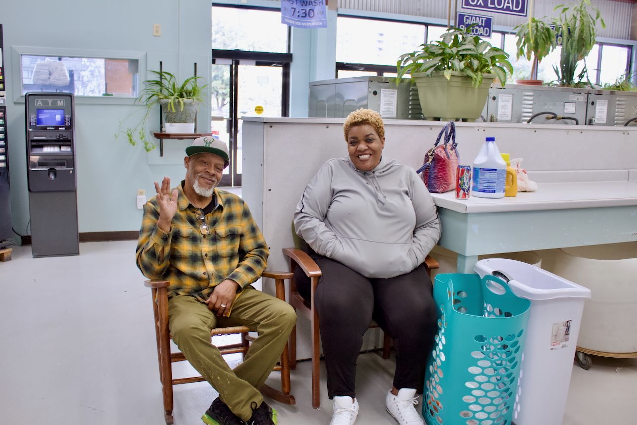 Man & Woman smiling in an Ellie's Laundromat