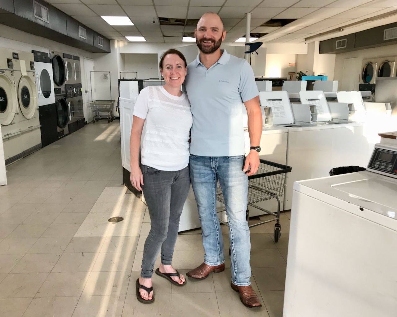 
Owners Sam & Elizabeth standing in their newly purchased laundromat