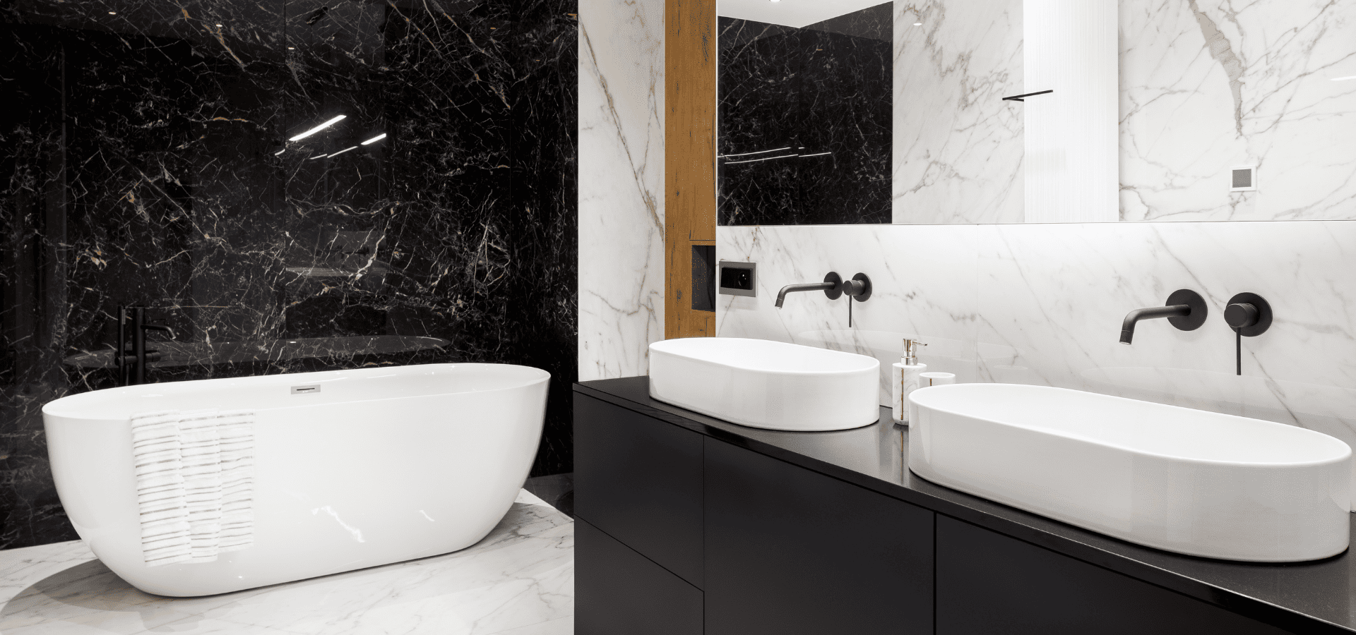 Luxury bathroom with white marble floor tiles and a mix of black and white marble wall tiles