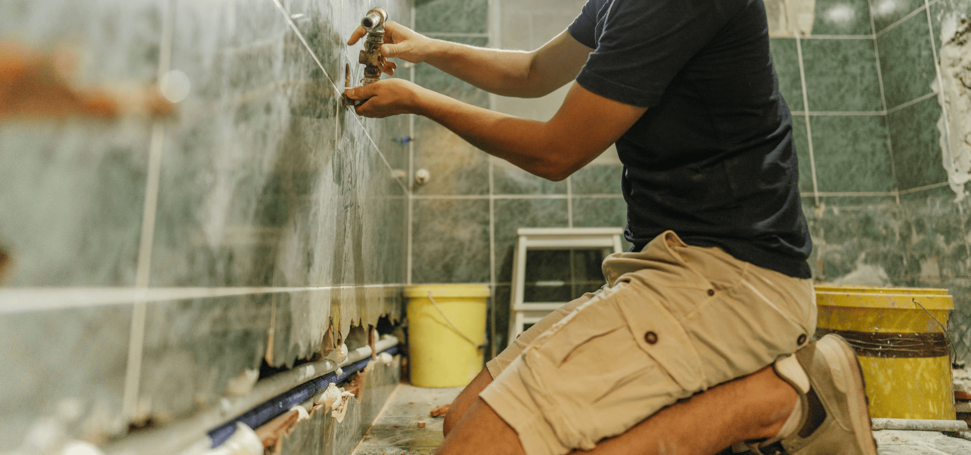 A homeowner in Denver installing ceramic bathroom wall tiles