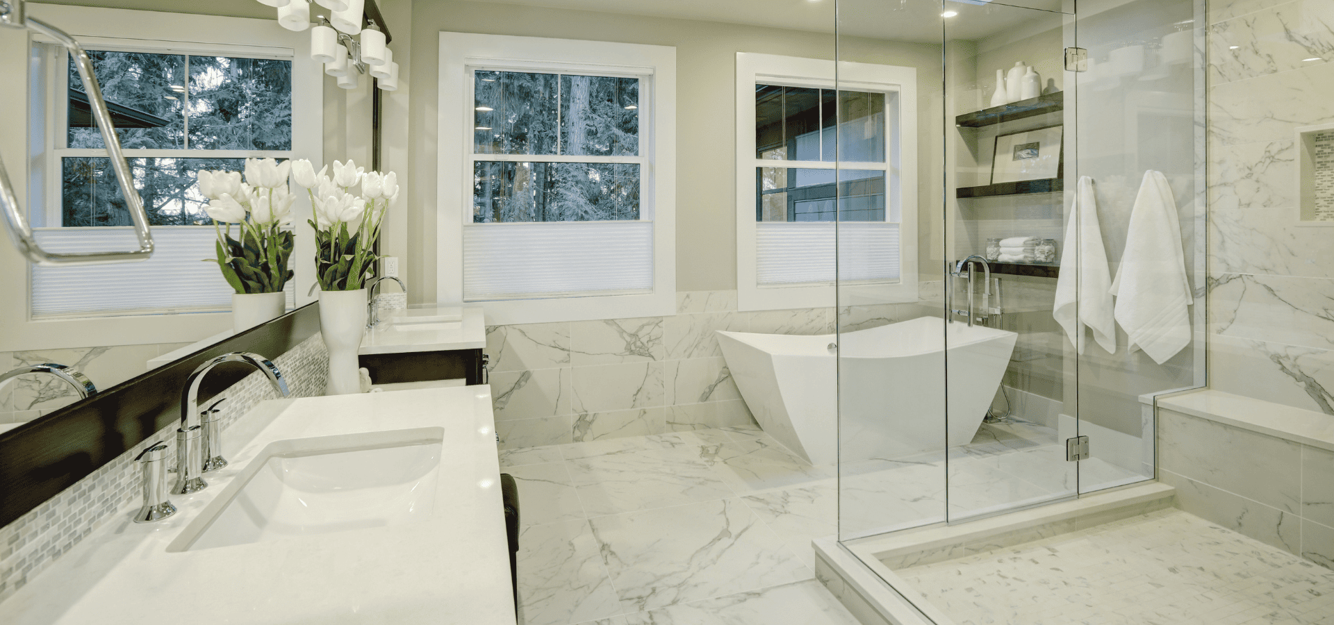 Luxurious master bathroom with marble tiles, double vanities, a shower, a bathtub, and a separate toilet