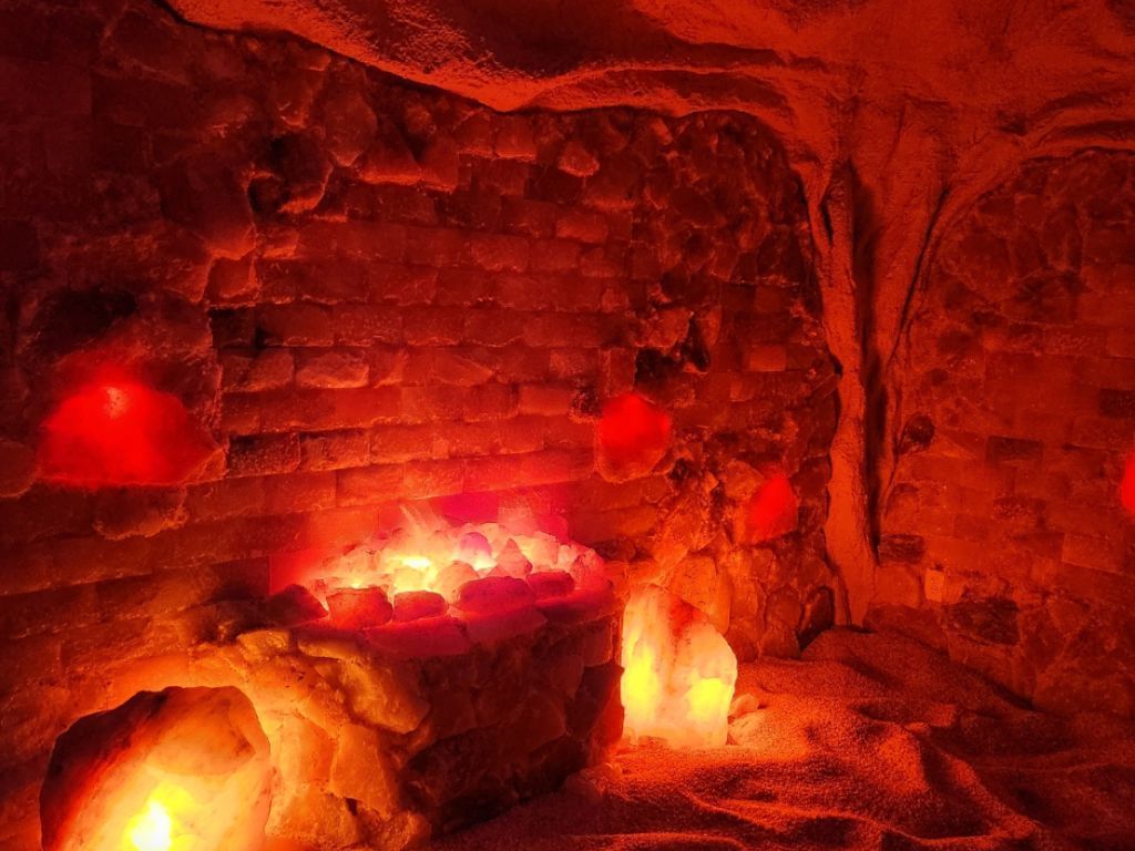 A cave filled with lots of rocks and candles.