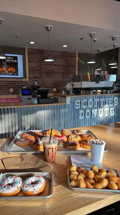 Interior of Scottie's Donuts with donuts, drinks, and counter. Sunlight streams in.