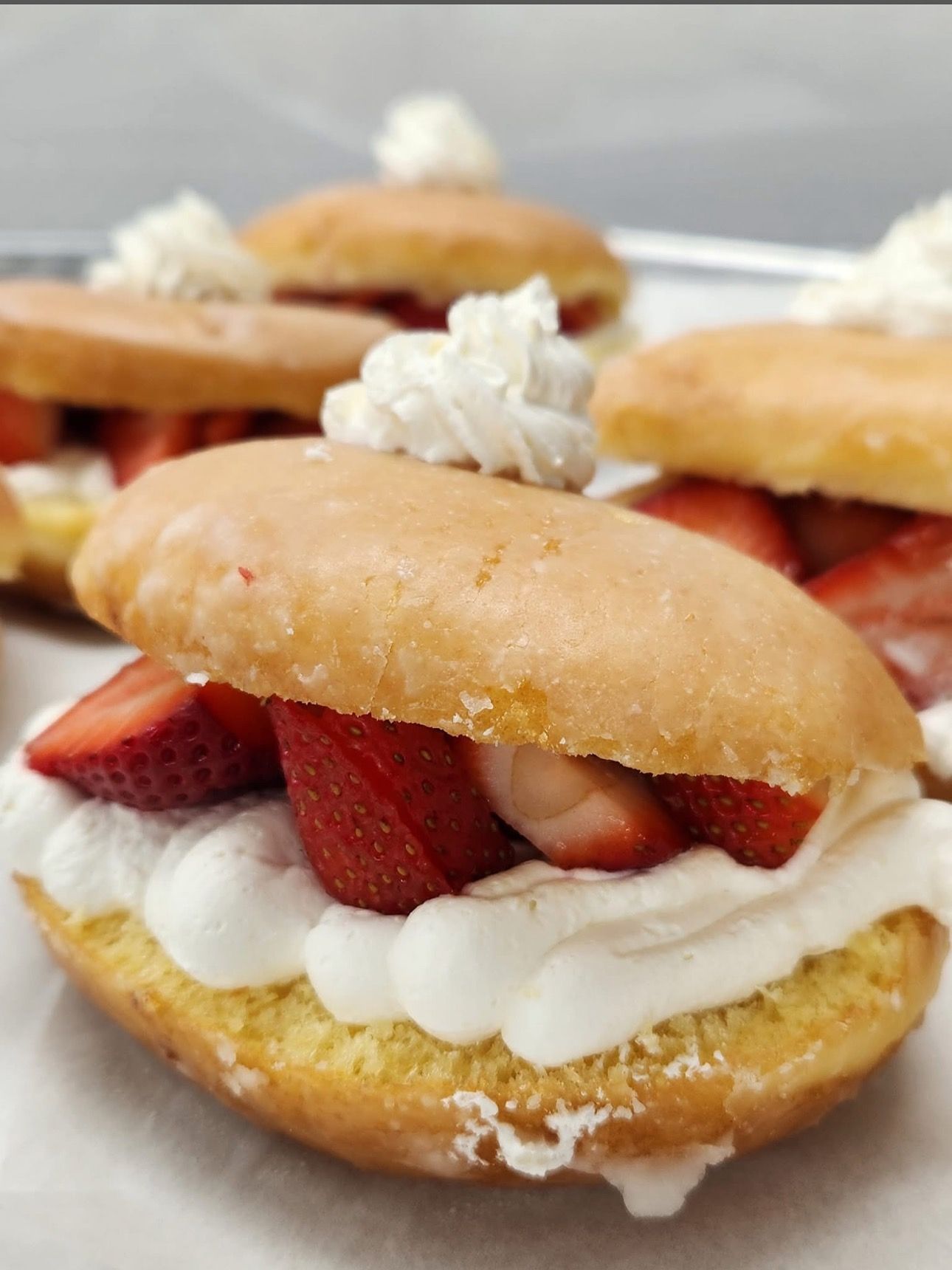 Strawberry donuts with whipped cream.