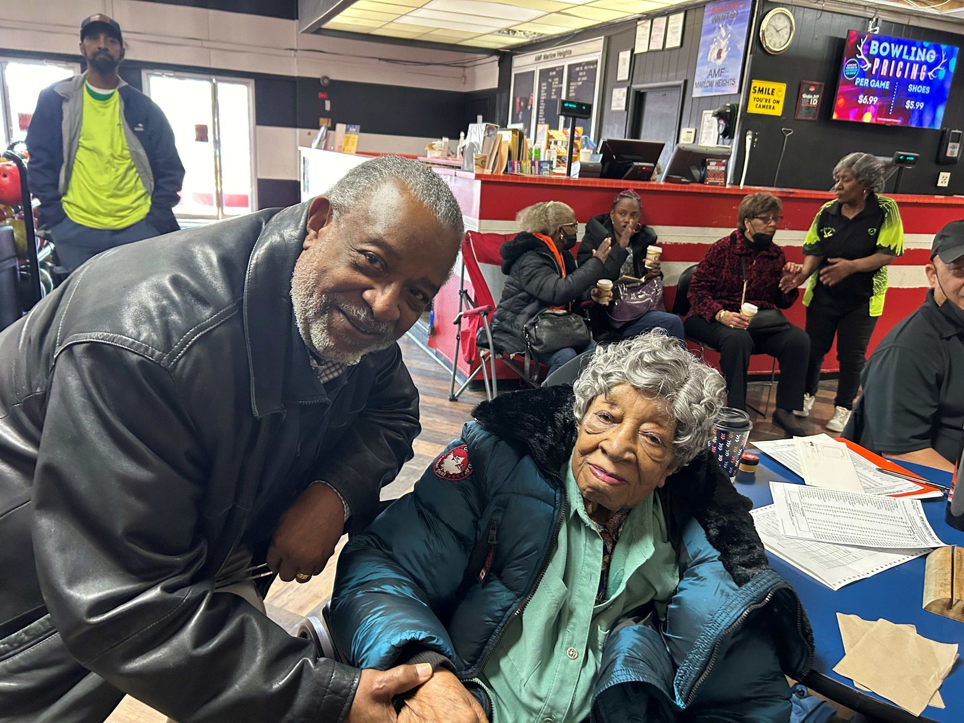 A man and a woman are holding hands in a restaurant.