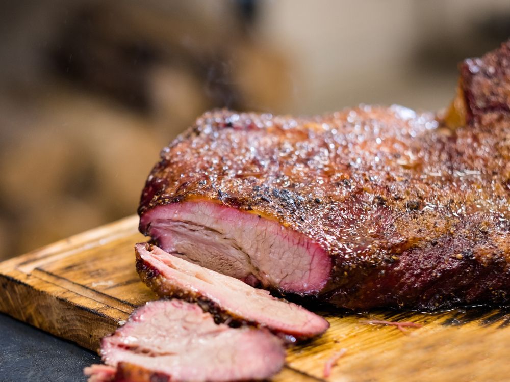 Hot smoked beef brisket on rustic wooden board — Wholesale Butchery in Walgett, NSW