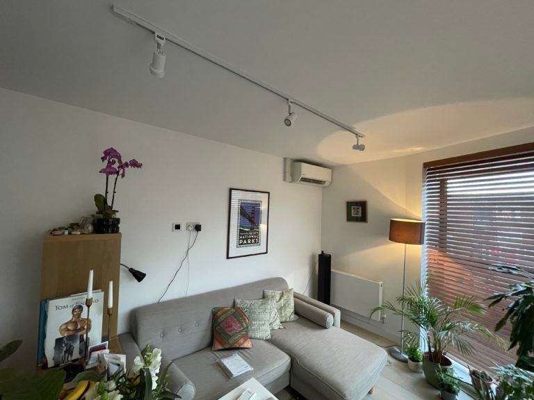 A living room with a couch and a picture on the wall