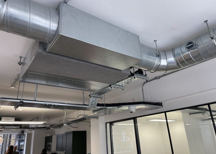 A room with a lot of pipes hanging from the ceiling.