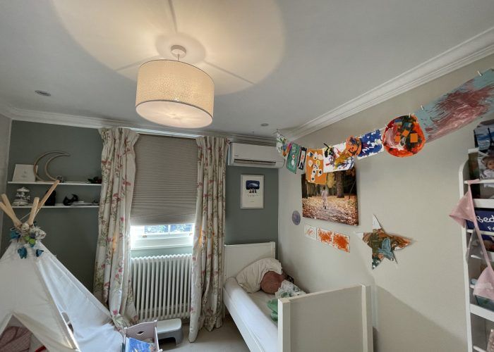 A child 's bedroom with a teepee and a bed