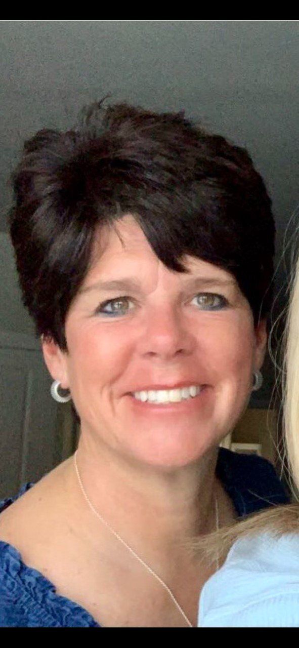 Face of a woman with short dark hair. 