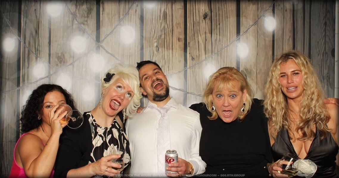 A group of people are posing for a picture in a photo booth.
