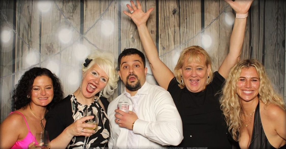 A group of people are posing for a picture in a photo booth.