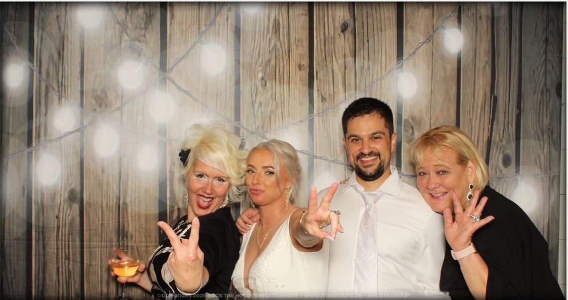 A group of people are posing for a picture in a photo booth.