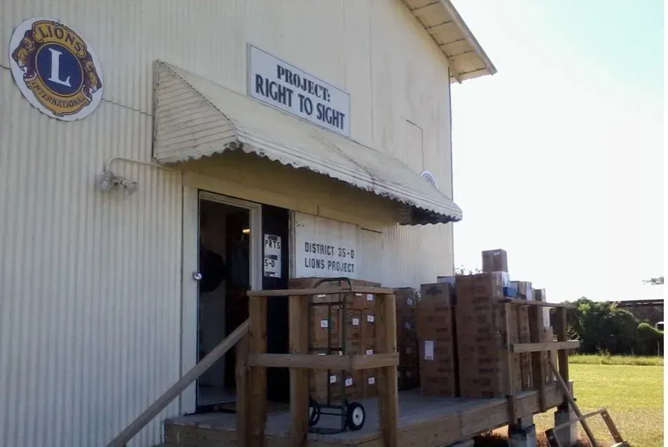 A white building with a sign that says 