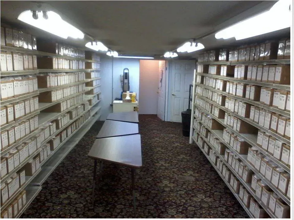 A room with a lot of shelves and a table