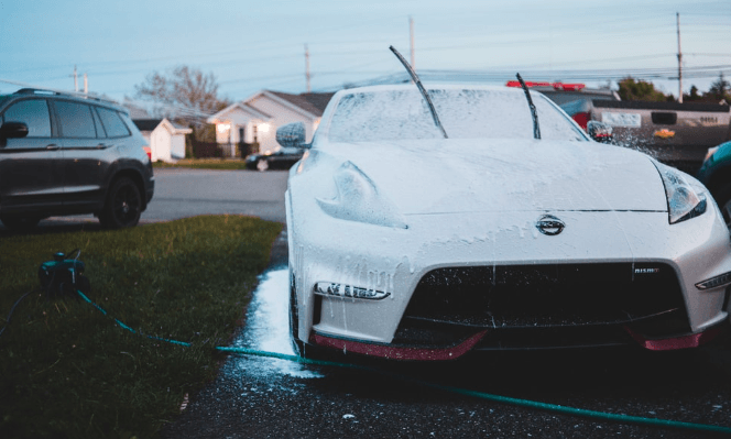 car drenched in snow with actiavted wiper blades