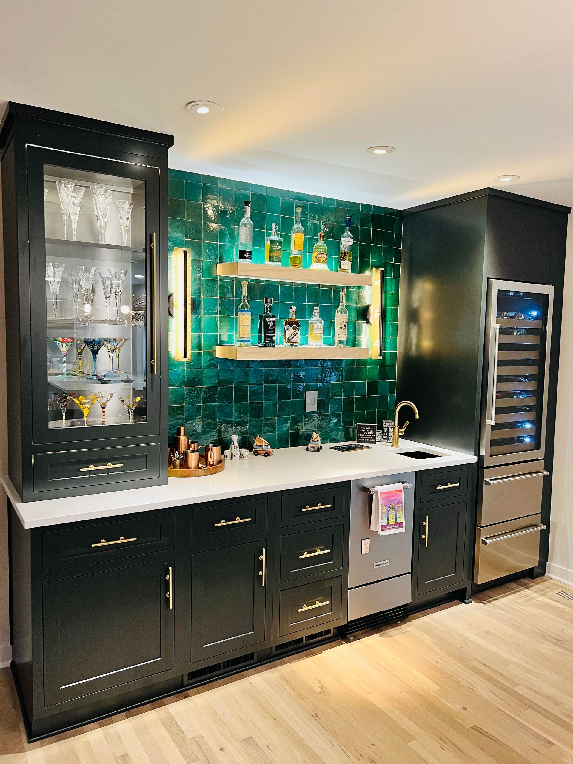 A kitchen with a bar and a refrigerator.