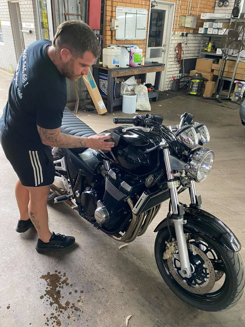 Man Applying Ceramic Coating on Motorbike — Car Cleaning in Coffs Harbour, NSW