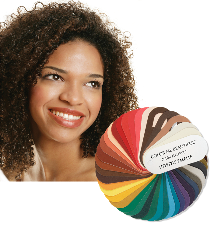 Smiling woman beside a fan of colorful hair color swatches