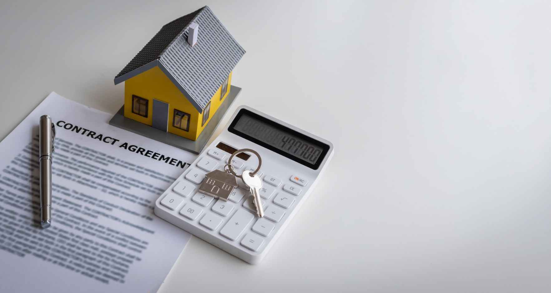A Calculator And A Model House On A Contract Agreement — One Lane Financial In Burdell, QLD