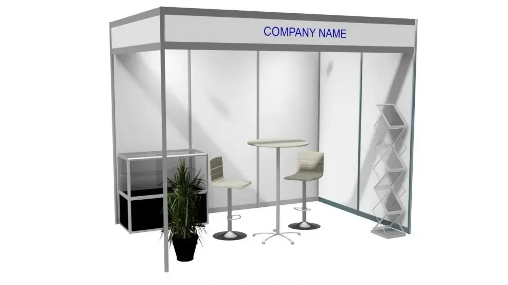 Trade show booth with white walls, table, chairs, shelving, and potted plant. 
