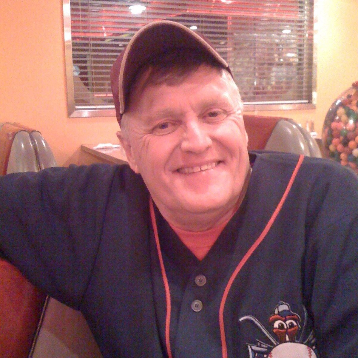 A man wearing a baseball jersey with the number 33 on it