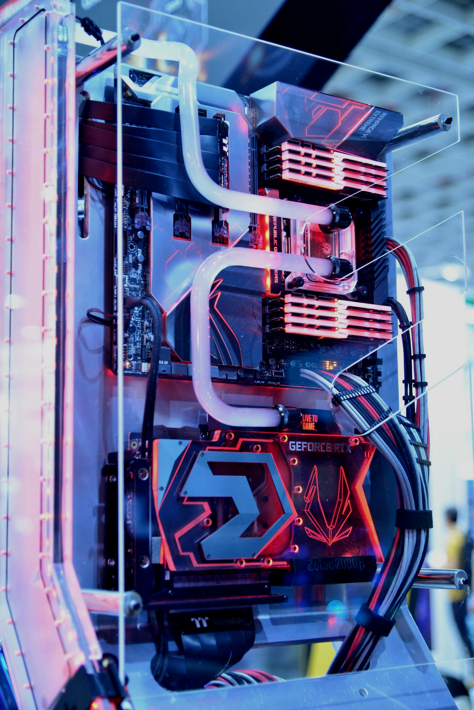 Custom PC with water cooling and red/blue lighting.